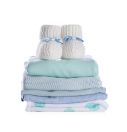 Photo of Stack of clean baby's clothes and small booties on white background