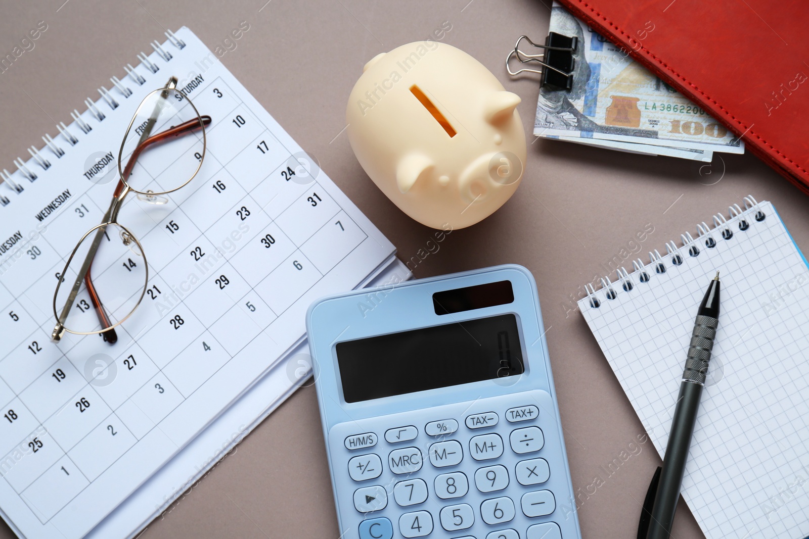 Photo of Flat lay composition with piggy bank and calculator on grey background