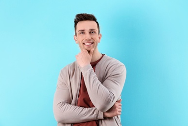 Charming young man on color background