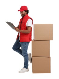 Happy young courier with stack of parcels and clipboard on white background