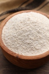 Photo of Quinoa flour in bowl on table, closeup