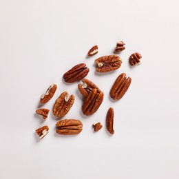 Photo of Delicious pecan nuts on white background, flat lay