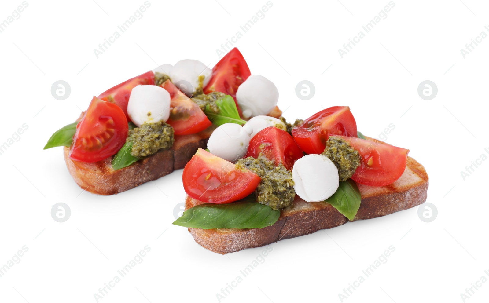 Photo of Delicious Caprese sandwiches with mozzarella, tomatoes, basil and pesto sauce isolated on white