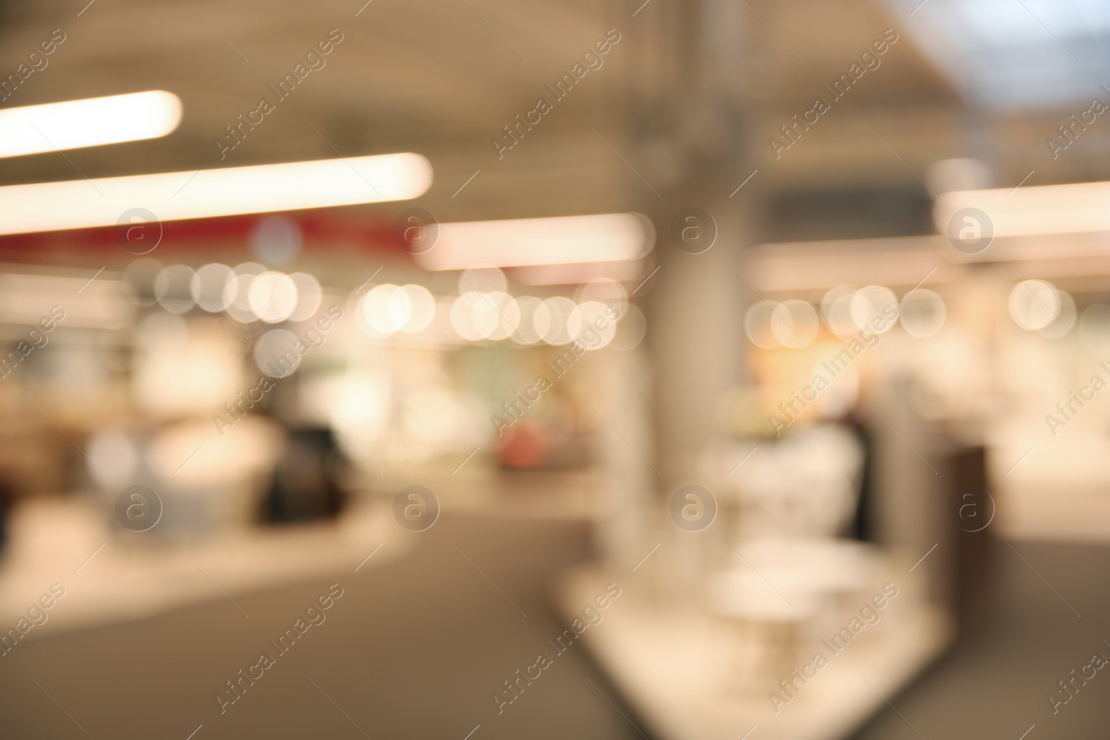 Photo of Blurred view of modern shopping mall interior