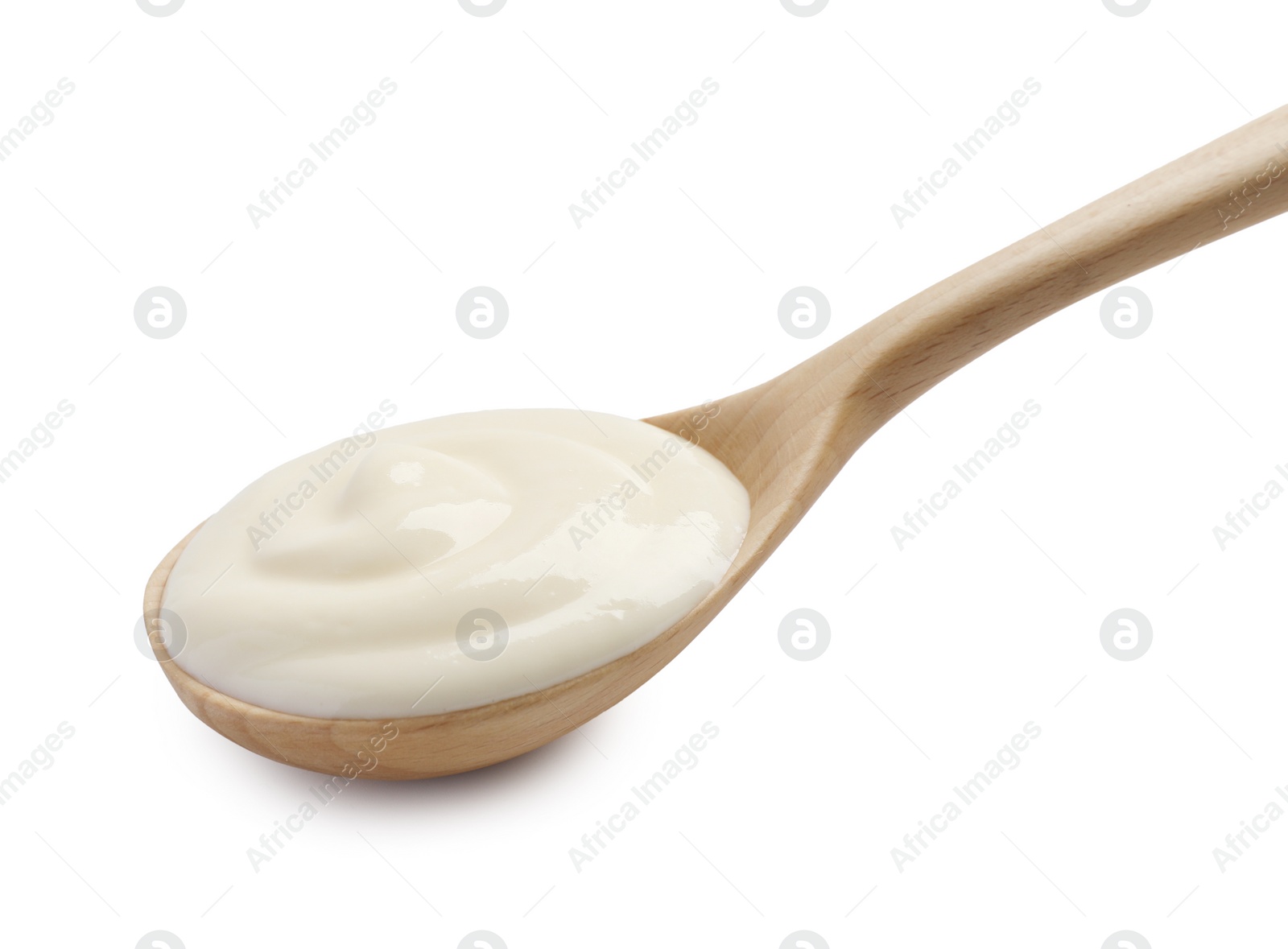 Photo of Natural yogurt in wooden spoon isolated on white