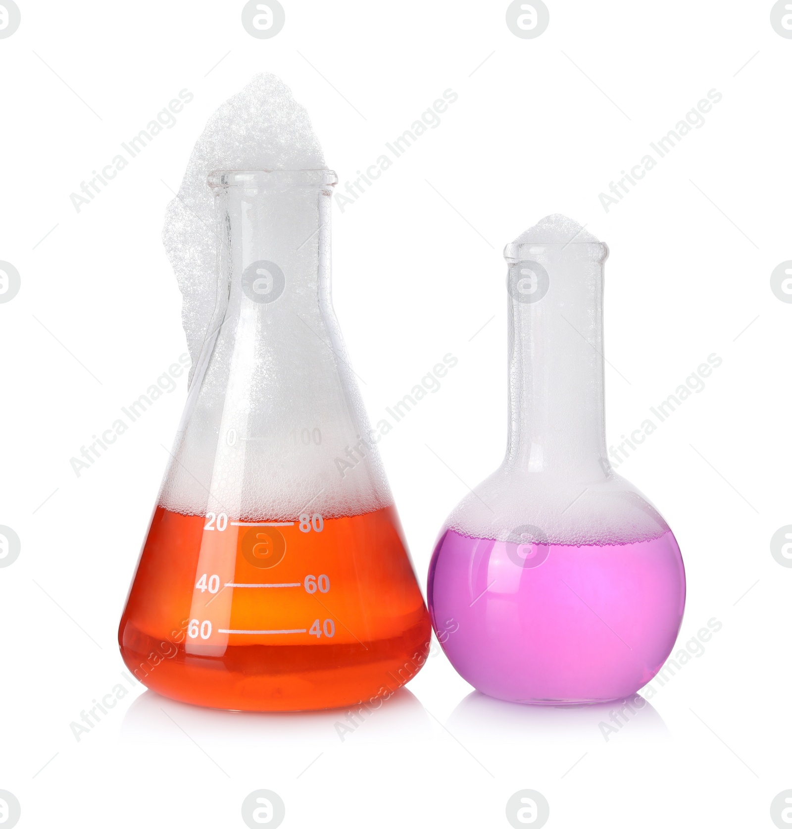 Photo of Laboratory flasks with colorful liquids isolated on white. Chemical reaction