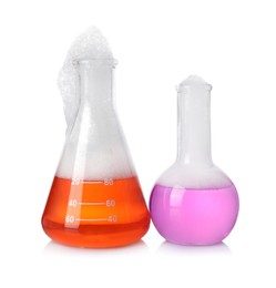 Photo of Laboratory flasks with colorful liquids isolated on white. Chemical reaction