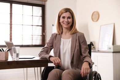 Portrait of woman in wheelchair at workplace