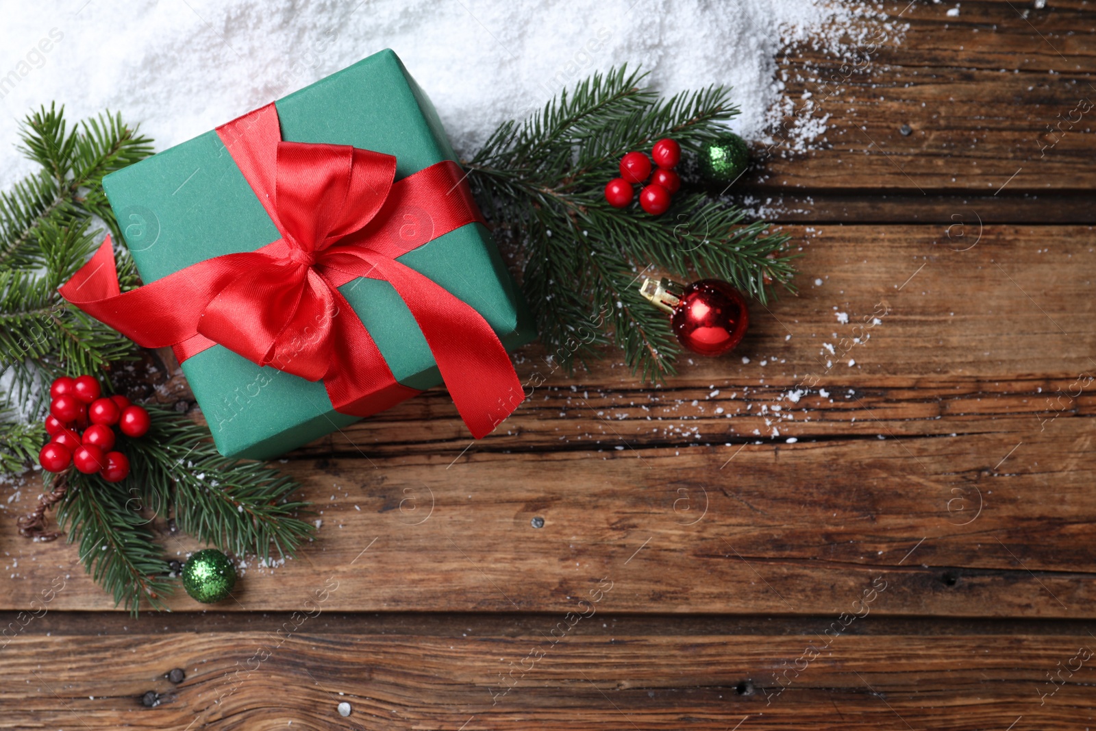 Photo of Flat lay composition with Christmas gift box on wooden table. Space for text