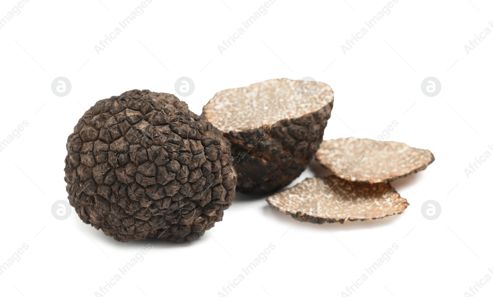 Photo of Cut and whole black truffles isolated on white