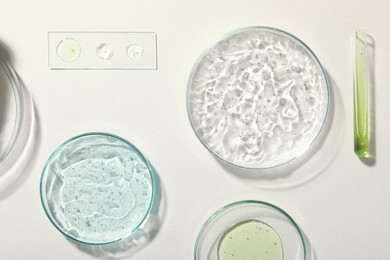 Photo of Flat lay composition with cosmetic gel and laboratory glassware on white background