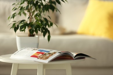 Fashion magazine on white table in living room, space for text