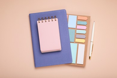Photo of Blank notebook, planner and stationery on beige background, flat lay
