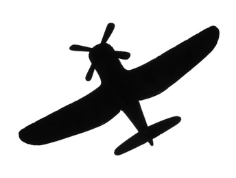 Dark silhouette of vintage toy military airplane on white background