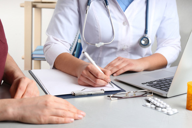 Doctor consulting patient in clinic, closeup. Medical service