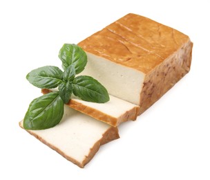 Photo of Cut smoked tofu and basil isolated on white