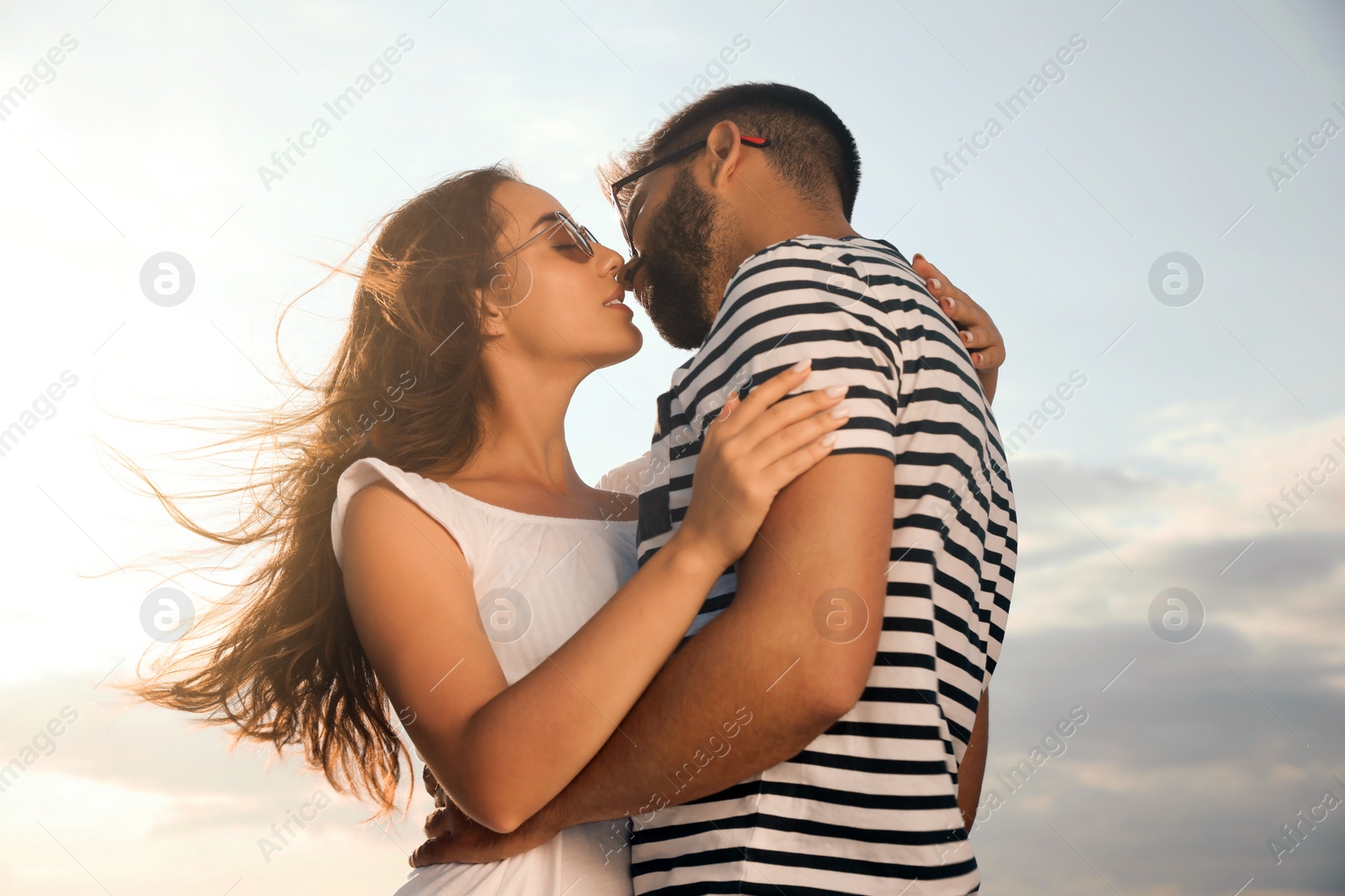 Photo of Lovely couple enjoying each other against sunny sky