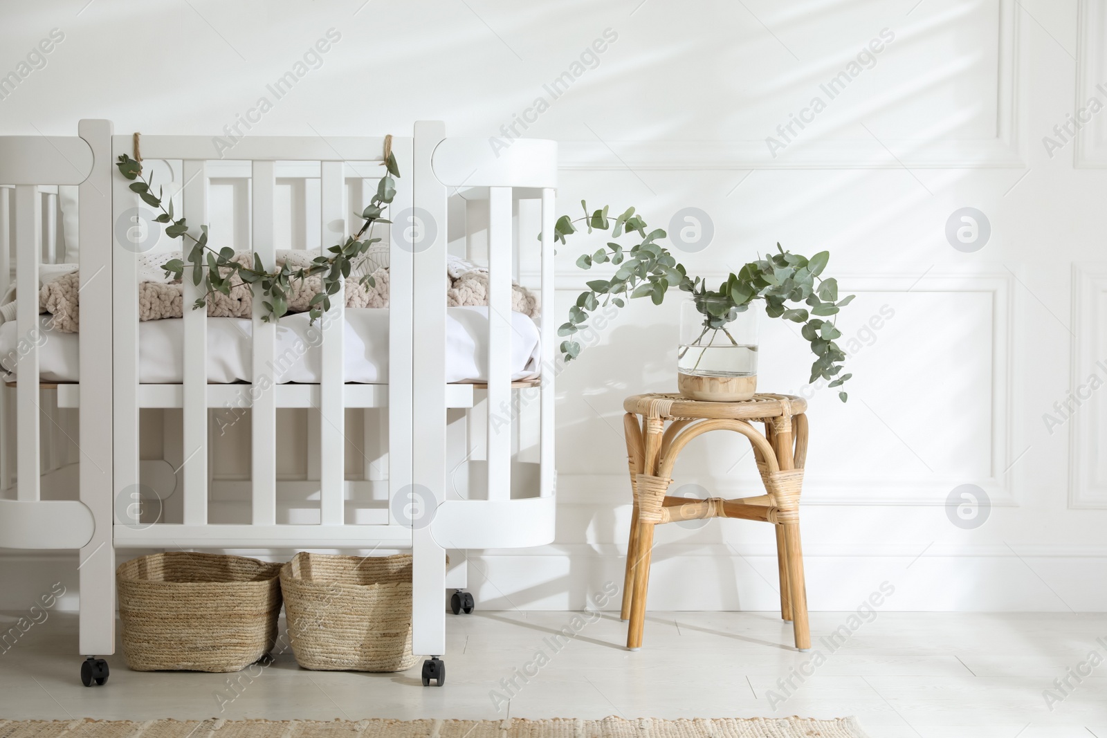 Photo of Stylish baby room decorated with eucalyptus branches