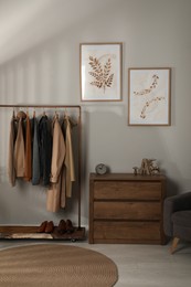 Modern dressing room interior with stylish clothes, shoes and decorative elements