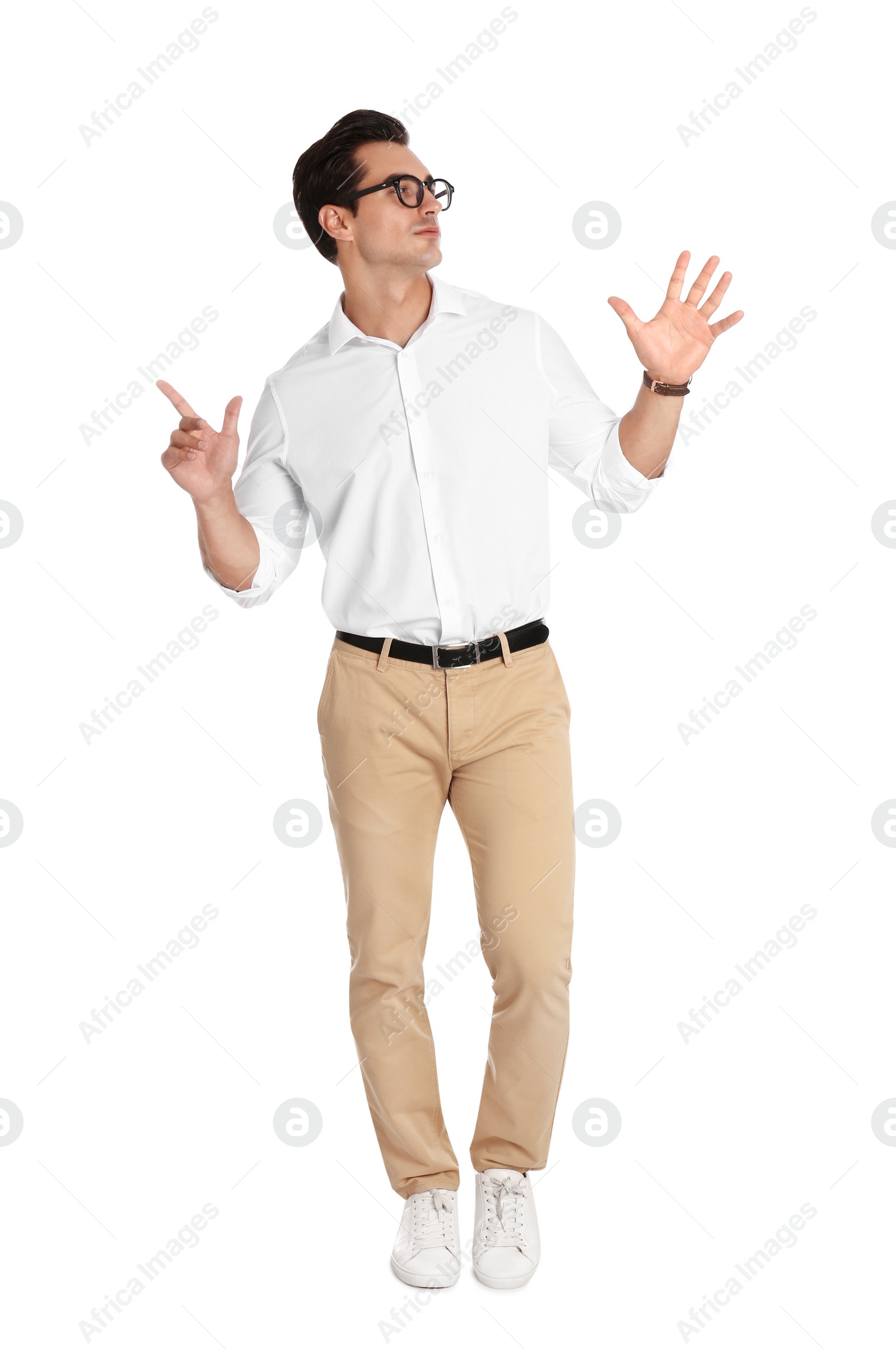 Photo of Handsome young man with glasses dancing on white background