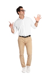 Handsome young man with glasses dancing on white background