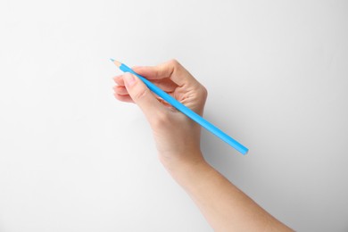 Photo of Woman with light blue pencil on white background, closeup