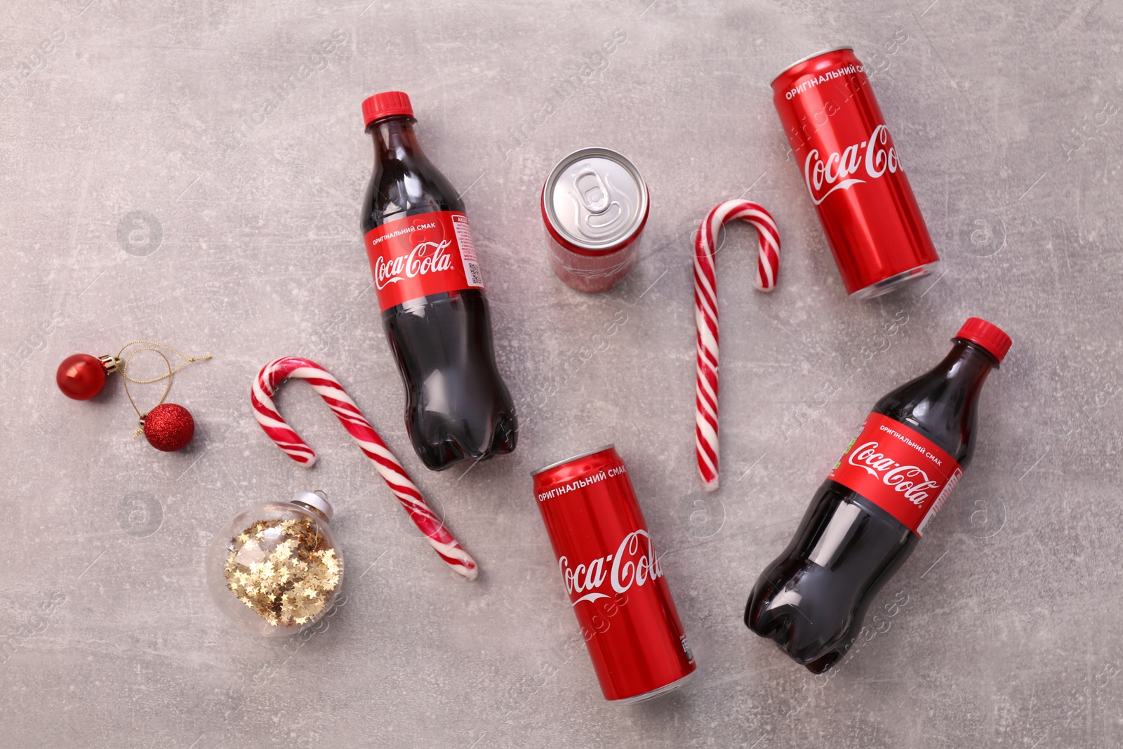 Photo of MYKOLAIV, UKRAINE - JANUARY 13, 2021: Flat lay composition with Coca-Cola cans and bottles on floor