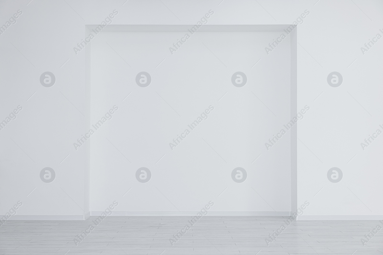 Photo of Empty room with niche in white wall during repair