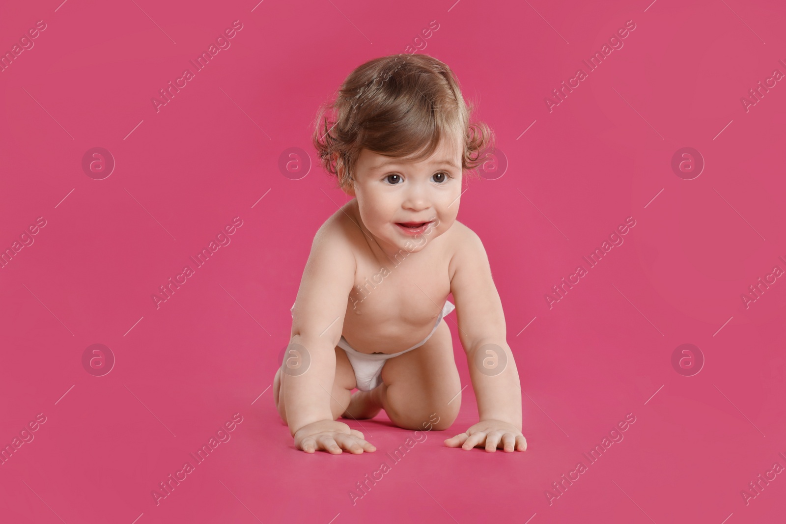 Photo of Cute little baby in diaper on pink background