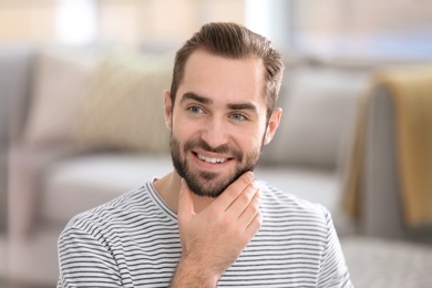 Photo of Portrait of young man with beautiful hair indoors