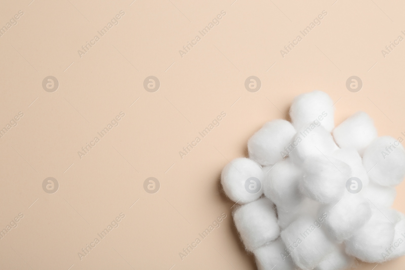 Photo of Many fluffy cotton balls on color background, top view. Space for text