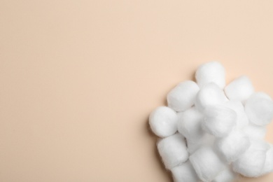 Many fluffy cotton balls on color background, top view. Space for text