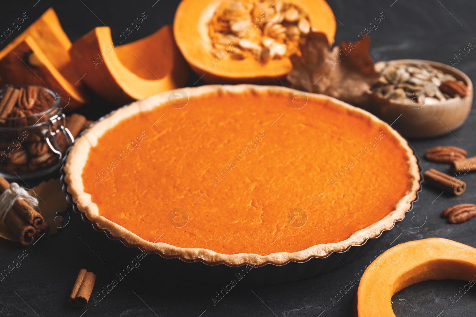 Photo of Delicious homemade pumpkin pie on black table