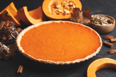 Photo of Delicious homemade pumpkin pie on black table