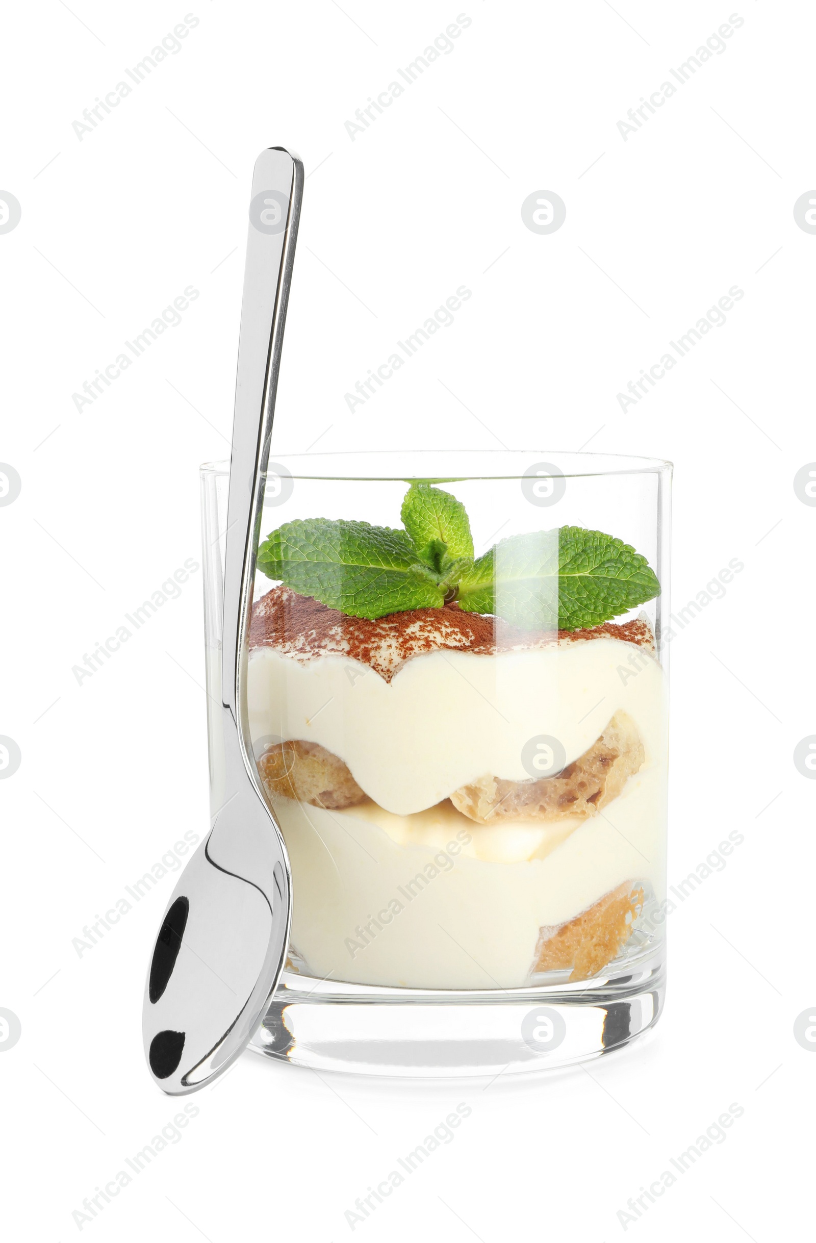 Photo of Delicious tiramisu in glass, mint leaves and spoon isolated on white