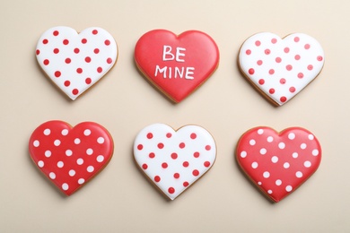 Delicious heart shaped cookies on beige background, flat lay. Valentine's Day