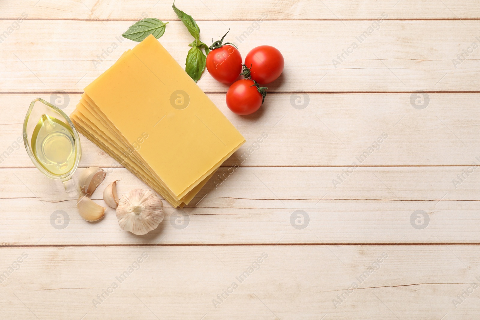 Photo of Ingredients for lasagna on white wooden table, flat lay. Space for text