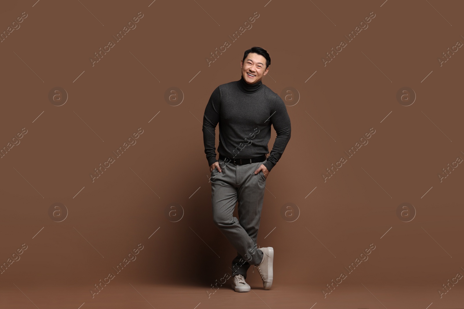 Photo of Full length portrait of happy man on brown background