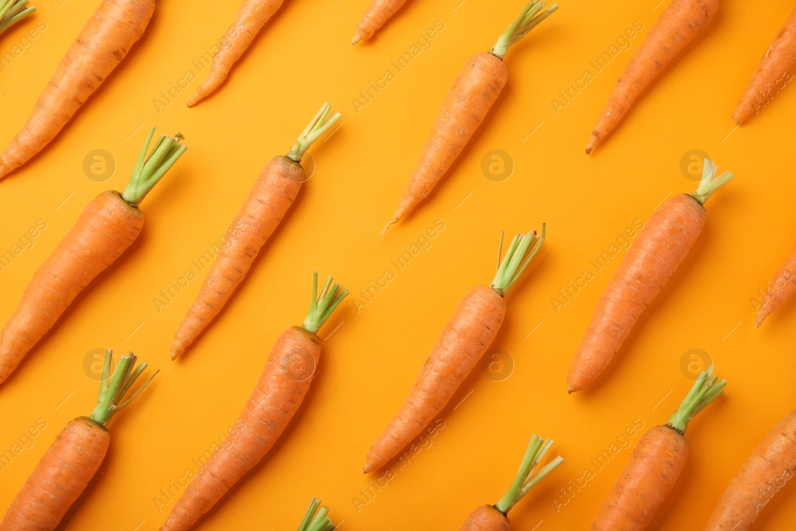 Photo of Flat lay composition with fresh carrots on color background