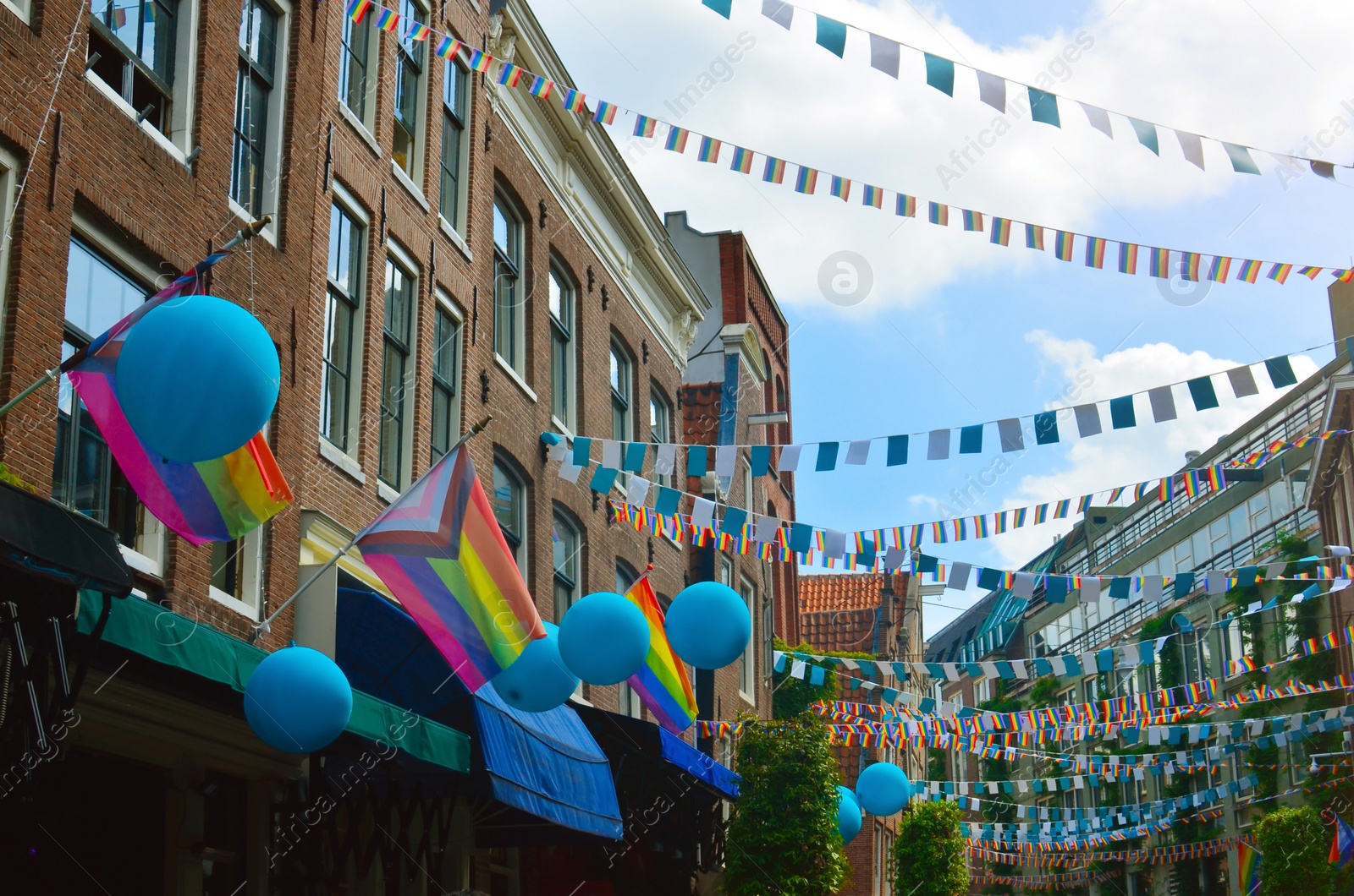 Photo of Picturesque view of city street with rainbow flags