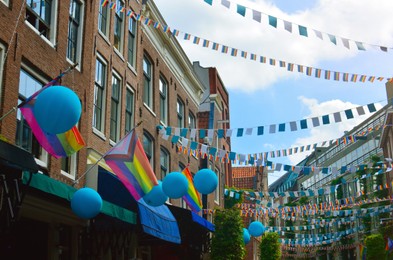 Photo of Picturesque view of city street with rainbow flags