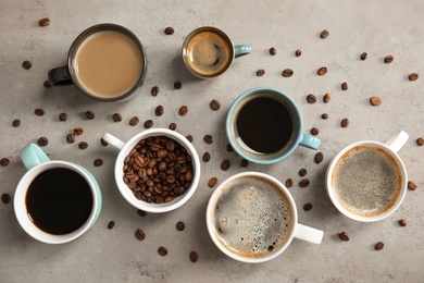 Photo of Flat lay composition with cups of coffee on gray background. Food photography