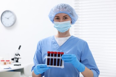 Laboratory testing. Doctor with blood samples in tubes at hospital