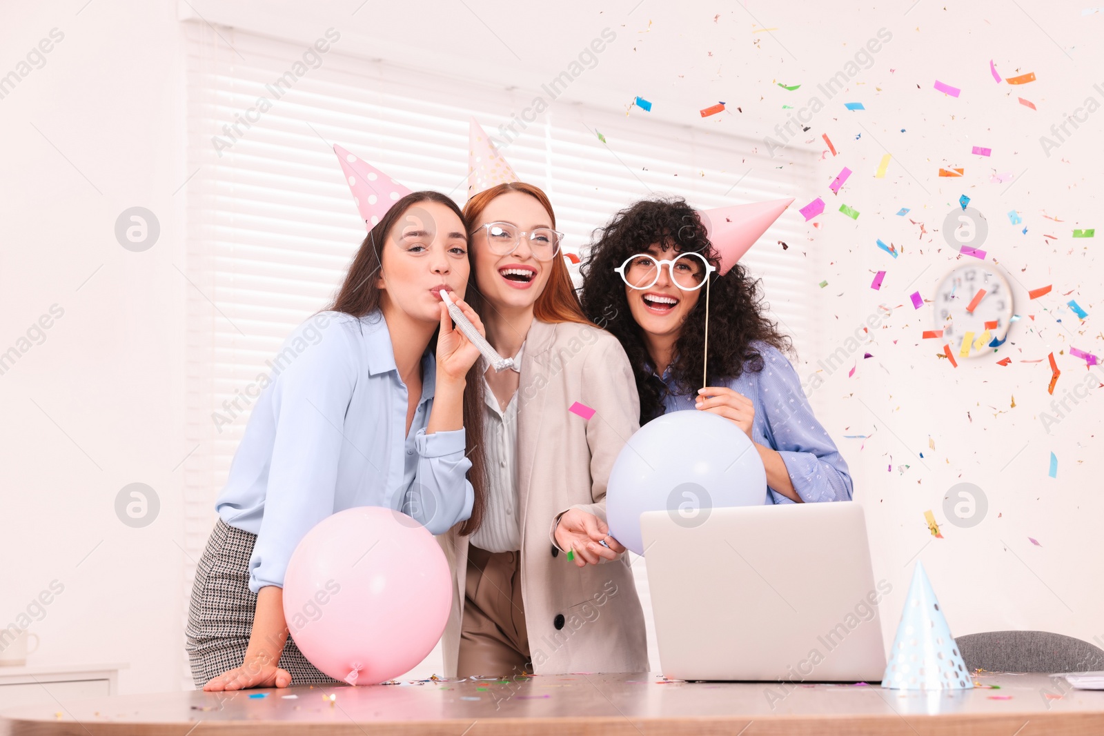 Photo of Coworkers having fun during office party indoors