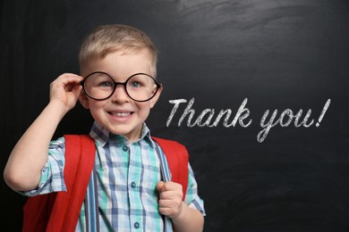 Cute little boy near chalkboard with phrase Thank You!