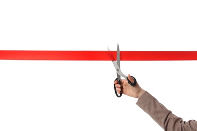 Photo of Woman in office suit cutting red ribbon isolated on white, closeup