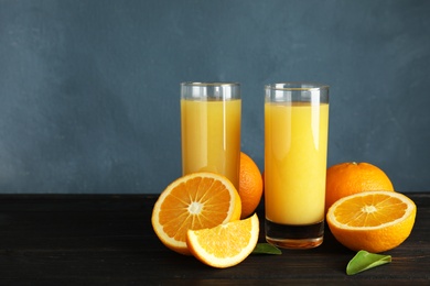 Photo of Composition with orange juice and fresh fruit on table, space for text