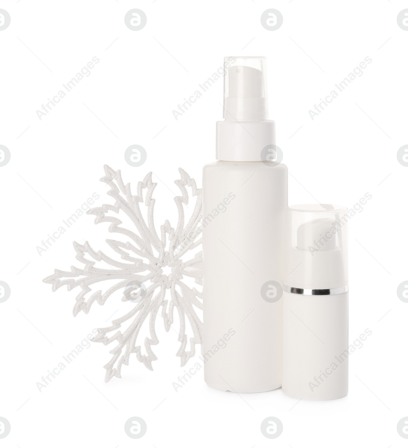 Photo of Bottles of hand cream and snowflake isolated on white. Winter skin care