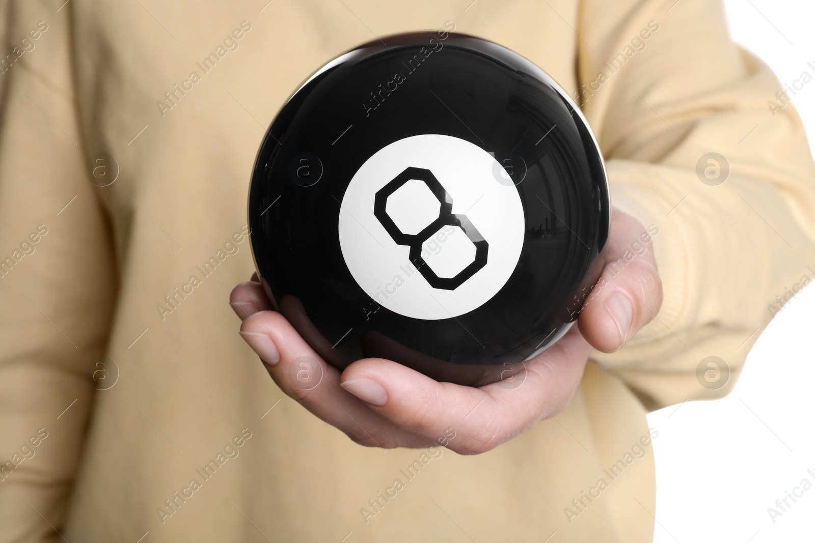 Photo of Woman holding magic eight ball on white background, closeup