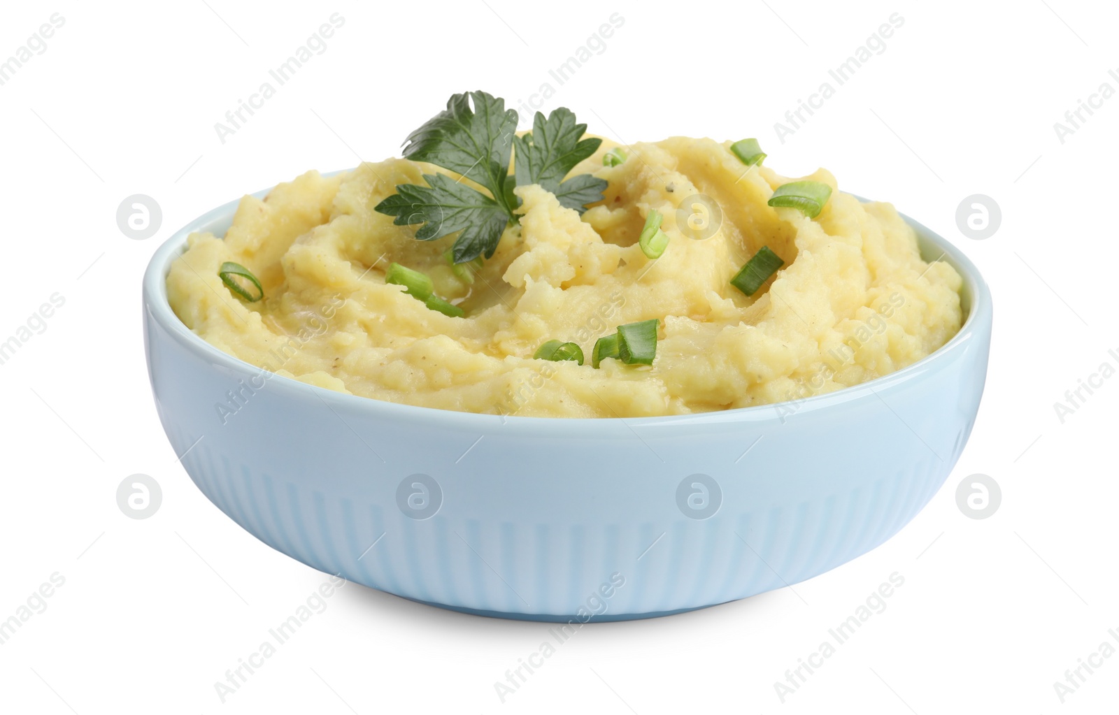 Photo of Bowl of tasty mashed potatoes with parsley and green onion isolated on white